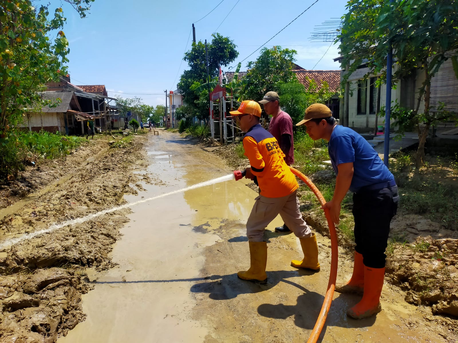 BPBD Kabupaten Tegal Berjibaku Bersihkan Lumpur Jalan Desa 